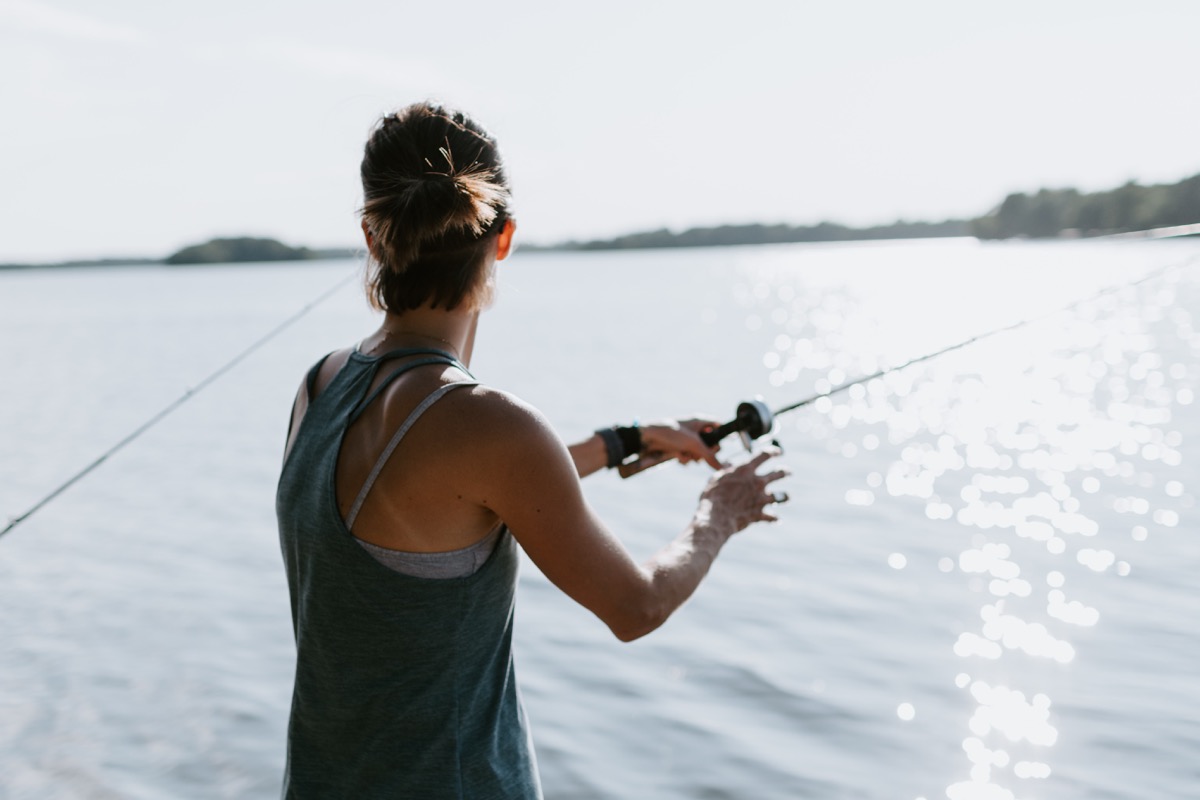 Woman fishing with fishing rod