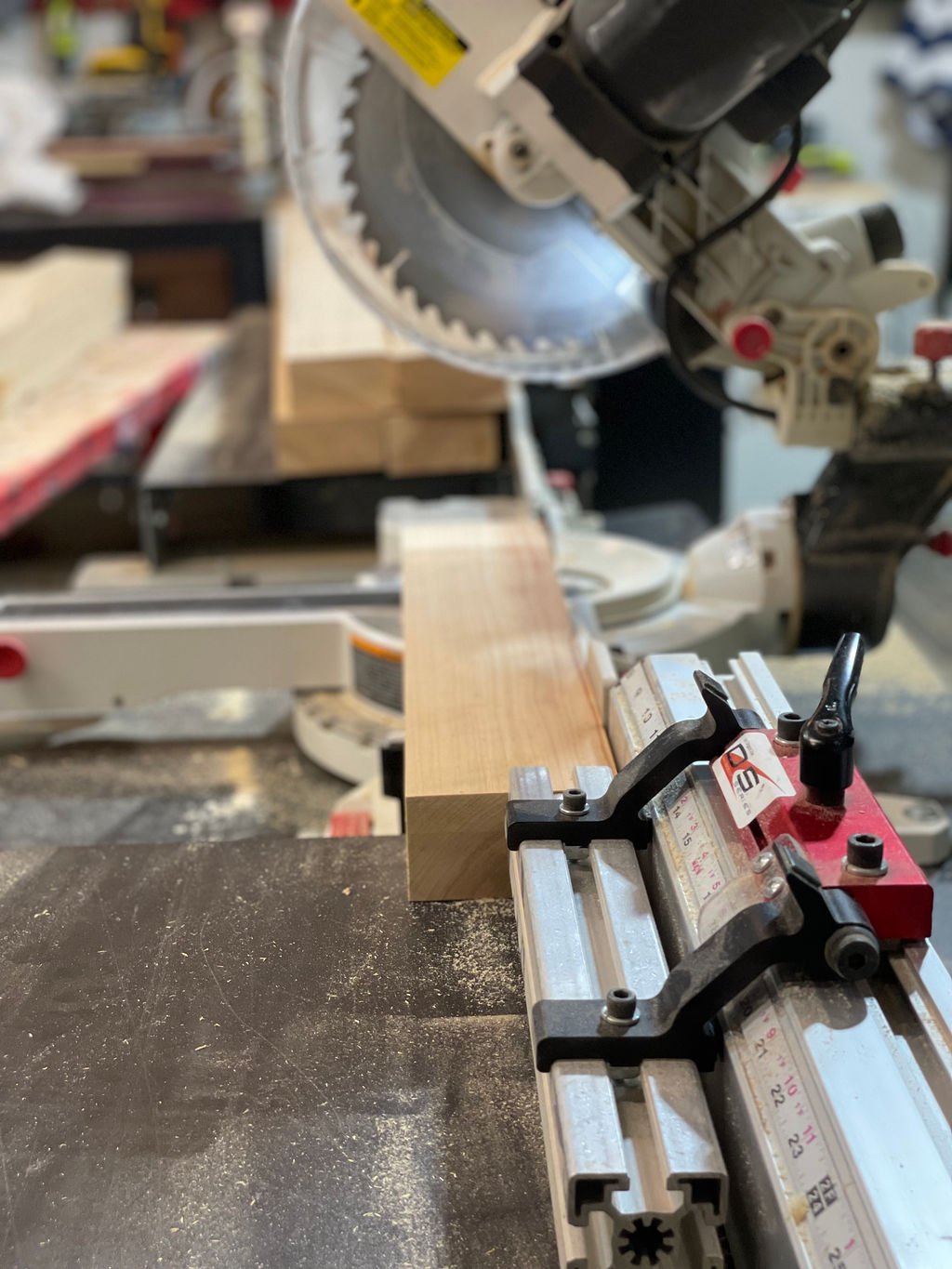 A piece of wood is ready to be cut while using Original Saw Company's Saw Measuring System to measure.