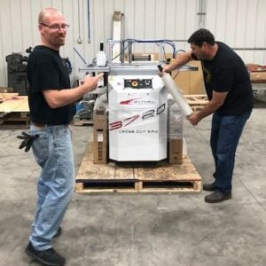 Packing up a Crosscut Power Saw by Chris and Dave. They wrapped the saw in stretch film. The saw is on a skid so it can be shipped to Atlanta for IWF.