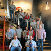 Employees at Original Saw Company on the showroom steps.